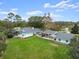 Aerial view showcasing the house, expansive yard, and detached structures at 2 Walnut Ct, Ormond Beach, FL 32174