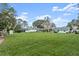 Large backyard with spacious lawn, detached workshop, and covered patio at 2 Walnut Ct, Ormond Beach, FL 32174