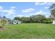 Expansive grassy backyard with mature trees and partial view of house at 2 Walnut Ct, Ormond Beach, FL 32174