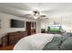 Spacious bedroom with large TV, dresser, and ensuite bathroom access at 2 Walnut Ct, Ormond Beach, FL 32174