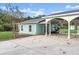 Covered carport with golf cart and access to backyard at 2 Walnut Ct, Ormond Beach, FL 32174