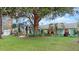 Charming light teal house with mature landscaping and large oak tree at 2 Walnut Ct, Ormond Beach, FL 32174