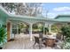 Inviting front porch with wooden deck, wicker furniture, and a charming setting at 2 Walnut Ct, Ormond Beach, FL 32174
