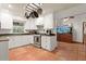 Modern kitchen with white cabinets, granite countertops, and pot rack at 2 Walnut Ct, Ormond Beach, FL 32174