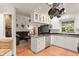 Kitchen features an island, white cabinets, and granite countertops at 2 Walnut Ct, Ormond Beach, FL 32174
