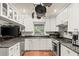 White kitchen with granite countertops and stainless steel appliances at 2 Walnut Ct, Ormond Beach, FL 32174