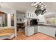 Open concept kitchen with island, white cabinets, and view of living room at 2 Walnut Ct, Ormond Beach, FL 32174