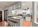 Modern kitchen with granite counters, white cabinets, and breakfast bar at 2 Walnut Ct, Ormond Beach, FL 32174