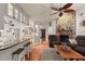 Open concept living room with kitchen, fireplace, and hardwood floors at 2 Walnut Ct, Ormond Beach, FL 32174