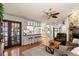 Living area with hardwood floors, stone fireplace and kitchen view at 2 Walnut Ct, Ormond Beach, FL 32174