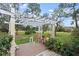 Peaceful pergola-covered deck with rocking chairs and a view of the yard at 2 Walnut Ct, Ormond Beach, FL 32174