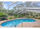 Screened-in pool area with spa and brick pavers at 2 Walnut Ct, Ormond Beach, FL 32174