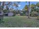 Large grassy backyard with shed and palm trees at 2039 Riverview Dr, Deland, FL 32720