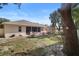 Back of house with screened patio, and a storage shed in the backyard at 209 Wellington Woods Ave, Deland, FL 32724