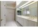 Bathroom with double vanity, large mirror, and tiled floors at 22 Old Macon Dr, Ormond Beach, FL 32174