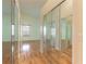 Spacious bedroom with mirrored closet doors and hardwood floors at 22 Old Macon Dr, Ormond Beach, FL 32174