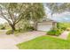 House exterior showcasing a large tree and spacious driveway at 22 Old Macon Dr, Ormond Beach, FL 32174