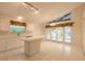 Eat-in kitchen with white cabinets, island and backyard access at 22 Old Macon Dr, Ormond Beach, FL 32174