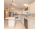 White kitchen with stainless steel appliances and breakfast bar at 22 Old Macon Dr, Ormond Beach, FL 32174