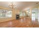 Spacious living room with hardwood floors, fireplace and chandelier at 22 Old Macon Dr, Ormond Beach, FL 32174