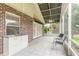 Spacious screened patio with tile flooring and ceiling fan at 22 Old Macon Dr, Ormond Beach, FL 32174