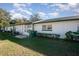 View of the back of the house with a patio and lawn at 225 N Hill Ave # 60, Deland, FL 32724