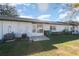 View of the back of the house with a patio and lawn at 225 N Hill Ave # 60, Deland, FL 32724
