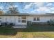 View of the back of the house with a patio and lawn at 225 N Hill Ave # 60, Deland, FL 32724