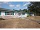 White house with green trim and a stone base at 225 N Hill Ave # 60, Deland, FL 32724