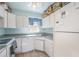 Kitchen features white cabinets and appliances at 225 N Hill Ave # 60, Deland, FL 32724