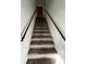 Indoor photo of a carpeted staircase with wooden railings at 2770 Botts Landing Rd, Deland, FL 32720