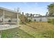 Backyard view with pergola, landscaping and fence at 2928 Bristol Ln, South Daytona, FL 32119