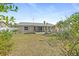 Large backyard with grassy area and mature trees at 2928 Bristol Ln, South Daytona, FL 32119
