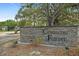 Coventry Forest entrance with stone wall and landscaping at 2928 Bristol Ln, South Daytona, FL 32119