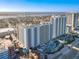 Aerial view of a beachfront high-rise building with pools and ocean views at 300 N Atlantic Ave # 1803, Daytona Beach, FL 32118