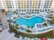 Aerial view of the resort pool area with a waterslide and lounge chairs at 300 N Atlantic Ave # 1803, Daytona Beach, FL 32118