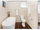 Bathroom with a soaking tub, toilet, and modern fixtures at 331 Sheldon St, New Smyrna Beach, FL 32168