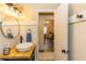 View of the bathroom vanity with a round mirror, modern faucet, and wooden countertop at 331 Sheldon St, New Smyrna Beach, FL 32168