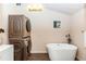 Modern bathroom with a soaking tub, stacked washer and dryer, and stylish fixtures at 331 Sheldon St, New Smyrna Beach, FL 32168