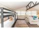 Bedroom with bunk beds, a sitting area, and exposed beams at 331 Sheldon St, New Smyrna Beach, FL 32168