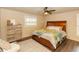 Inviting bedroom with a king-size bed, dresser, ceiling fan, and plush rug at 331 Sheldon St, New Smyrna Beach, FL 32168