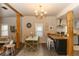 Dining area with a wood table, green chairs, and an open view to the kitchen at 331 Sheldon St, New Smyrna Beach, FL 32168