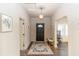 Welcoming entryway with dark wood-look floors, a patterned rug, and a black door at 331 Sheldon St, New Smyrna Beach, FL 32168