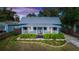 Charming blue cottage with metal roof, white trim, and landscaped front yard at 331 Sheldon St, New Smyrna Beach, FL 32168