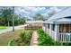 Stone pathway and lush greenery leading to a blue and white cottage at 331 Sheldon St, New Smyrna Beach, FL 32168