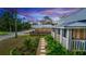 Landscaped pathway leading to a charming blue cottage with a white picket fence at 331 Sheldon St, New Smyrna Beach, FL 32168