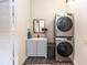 Laundry room with a stacked washer and dryer, a vanity, and ample storage space at 331 Sheldon St, New Smyrna Beach, FL 32168