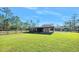 Backyard with covered storage area at 3782 Pine Cone Ln, Ormond Beach, FL 32174
