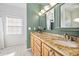 Elegant bathroom with double vanity, granite countertop, and large mirror at 3782 Pine Cone Ln, Ormond Beach, FL 32174