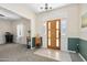 Bright entryway with tile floor and wood door at 3782 Pine Cone Ln, Ormond Beach, FL 32174